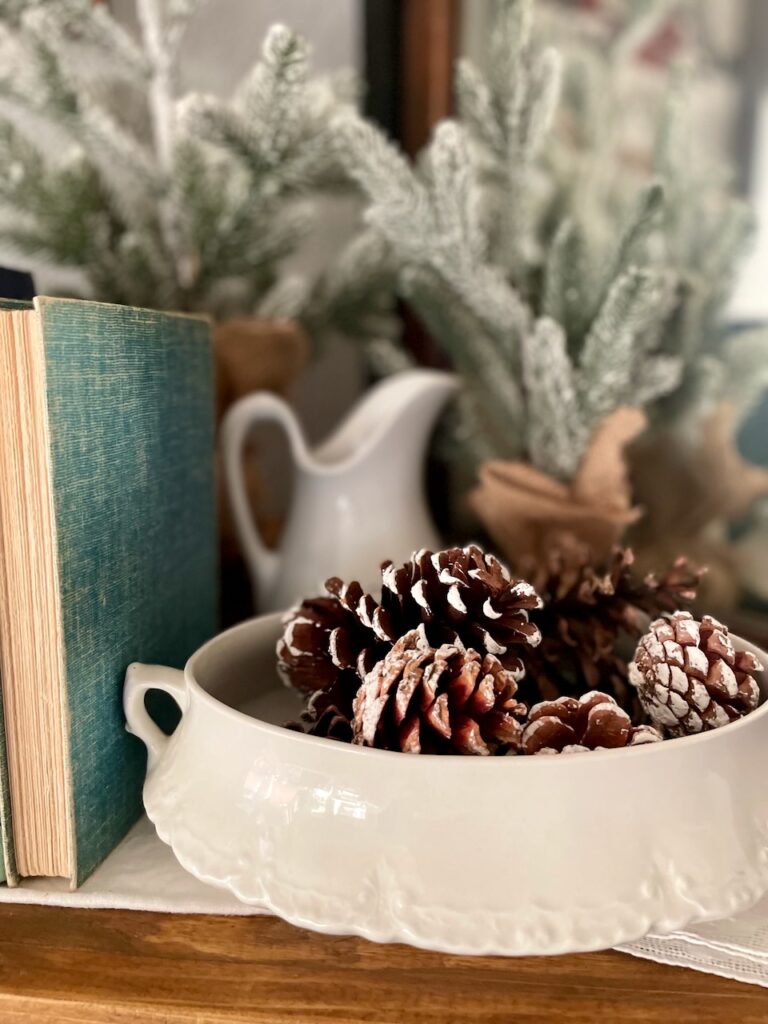 pinecones styled in a vintage ironstone tureen on a mantel for natural winter decor