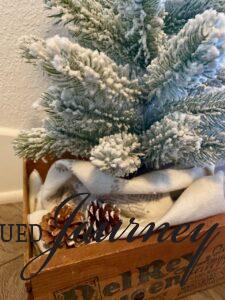 pinecones with a small tree in an entryway for winter decor