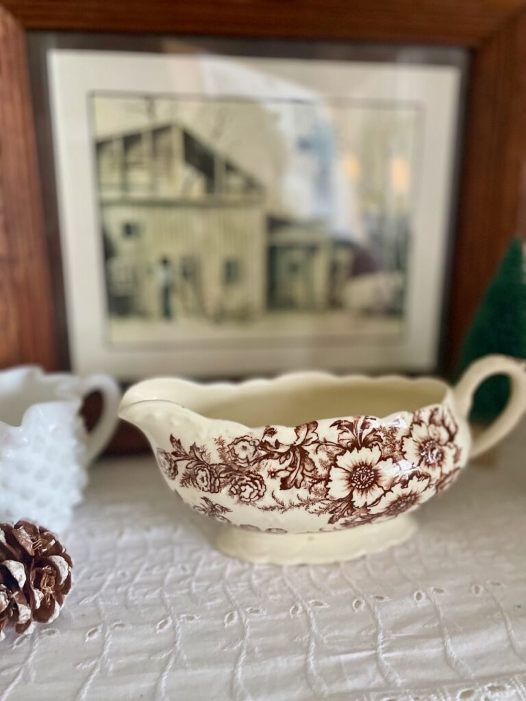 unexpected winter decorating hacks with thrifted and vintage finds- brown transferware gravy boat styled for winter