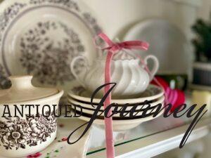 vintage valentines decor with dishes and ribbon styled in a hutch