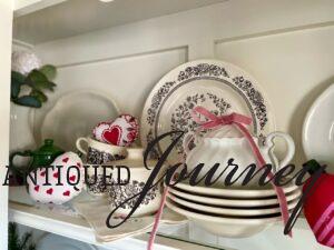 faux greenery styled in a hutch for valentine decor