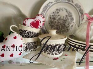 vintage dishes styled with fabric hearts for valentines day hutch decor