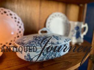 vintage blue and white thrifted decor styled in an antique curio cabinet