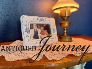 thrifted frame styled on top of a curio cabinet
