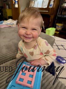Molly smiling with toys