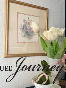 a vintage floral watercolor painting styled on a mantel for Spring