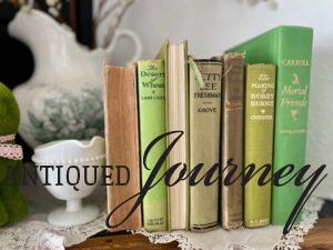 vintage green books styled on a mantel for spring decorating 
