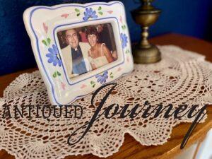 thrifted doily displayed on top of an antique curio cabinet