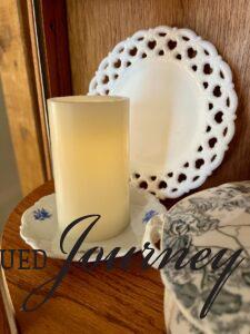 vintage blue and white plates styled in a curio cabinet