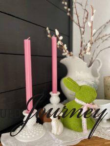 milk glass taper candle holders styled with pink candles on a mantel for spring