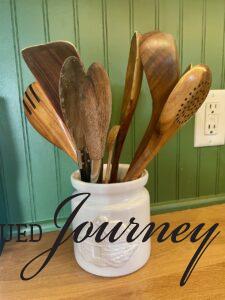 vintage utensil crock on a kitchen countertop for affordable kitchen decor
