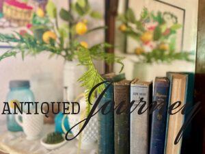 vintage blue books styled on a mantel for summer decor