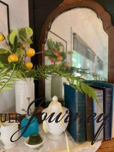 vintage milk glass styled for summer on a mantel