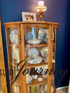 antique curved cabinet filled with vintage decor for master bedroom decor