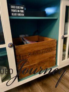 a thrifted wooden crate used for storage home decor
