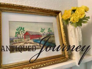 vintage summer art on an entryway shelf