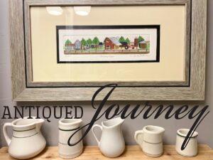 a vintage creamer collection styled on a bathroom shelf