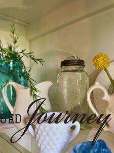 styling vintage decor in a hutch using an odd number of items