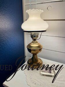 vintage brass lamp for thrifty bedroom decor on a budget