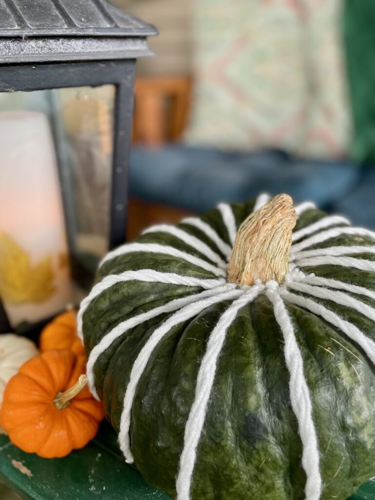 DIY pumpkin decor for fall styled on a patio