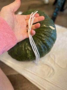 cutting yarn for pumpkin DIY