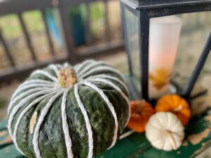 sweater-wrapped pumpkin decor styled on a patio