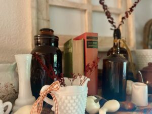 fall shelf decor with vintage amber bottles and thrifted finds
