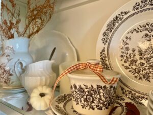 vintage and thrifted fall decor styled in a hutch