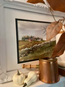thrifted art used in an entryway for fall decorating