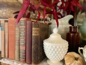 vintage fall books styled on a mantel