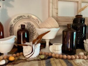 vintage and thrifted fall decor on a shelf