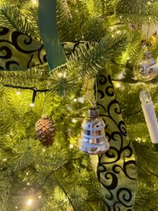 vintage bell Shiny Brite ornament on a tree