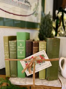 a row of green vintage books for Christmas mantel decor ideas
