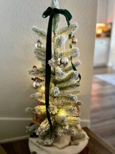 silver Shiny Brite ornaments on a flocked tree