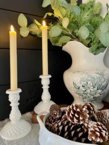 thrifted vintage decor styled on a winter mantel