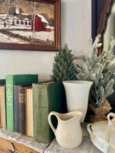 old antique and vintage books used for winter decor on a mantel