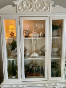 vintage decor styled in a hutch with a vintage lamp