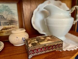 heirloom decor styled inside an antique curio cabinet