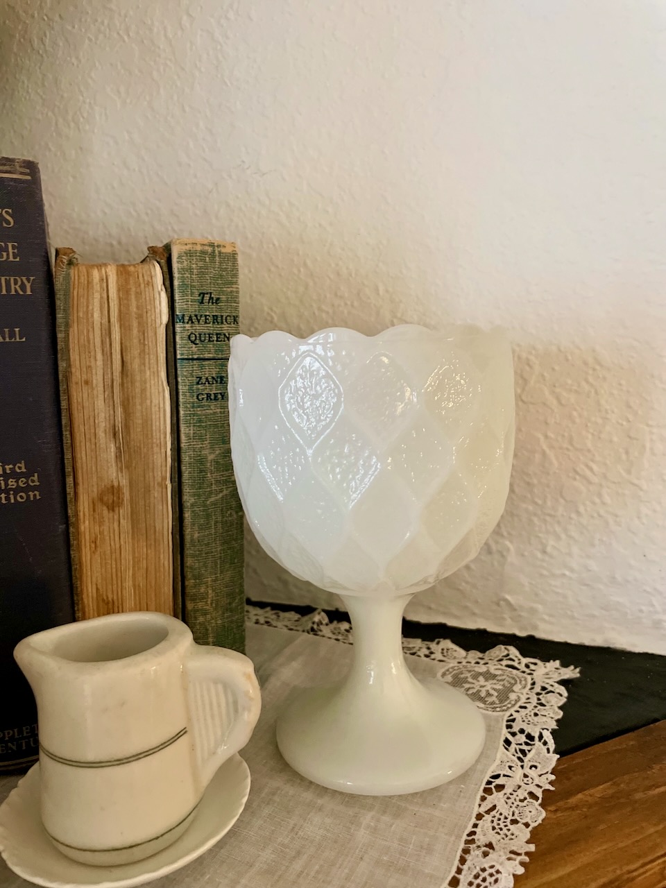 thrifted milk glass compote styled on a mantel