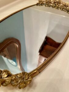 inherited vintage mirror tray styled on a bathroom counter