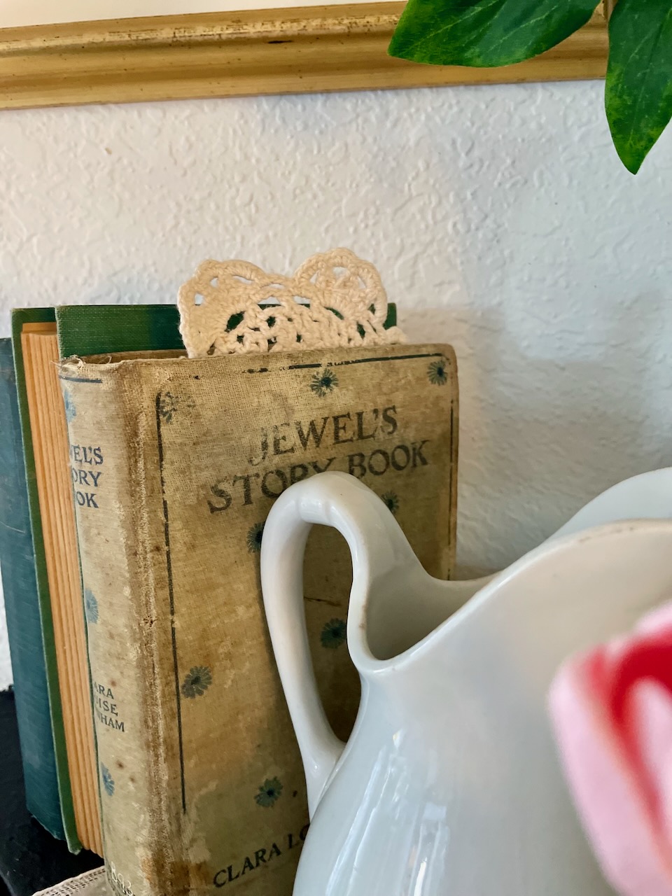 vintage embroidered doily sticking out of a vintage book for easy home decor ideas