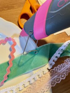 gluing down ribbon on homemade Easter egg craft