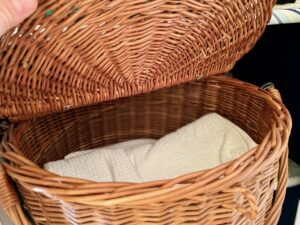thrifted basket used to hold bath towels budget home decor