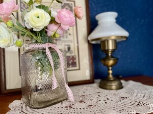a vintage doily styled under a lamp 