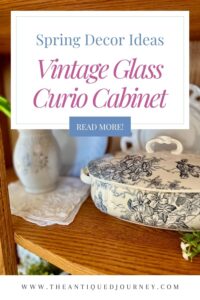 thrifted blue and white spring decor arranged on the shelves of a vintage curio cabinet