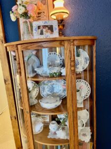 Rachel from The Antiqued Journey styling her antique wood curio cabinet for spring