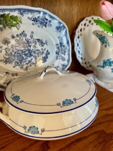  close up of blue and white ironstone pieces displayed inside a glass curio cabinet