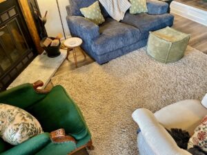 Thrifted living room with a mix of vintage furniture, antique finds, and secondhand wall art