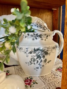 A thrift store haul of vintage collectibles including milk glass and ironstone
