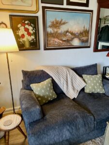 Styled living room vignette featuring thrifted lamps, art, and decor on a budget